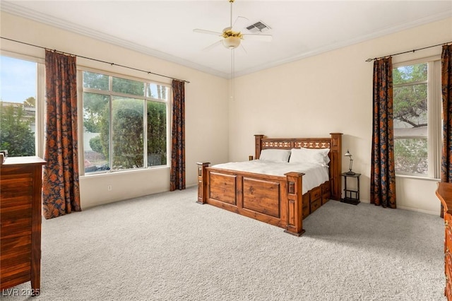 bedroom featuring multiple windows, light colored carpet, and ceiling fan