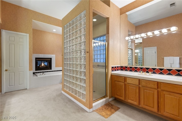 bathroom with a multi sided fireplace, vanity, and shower with separate bathtub