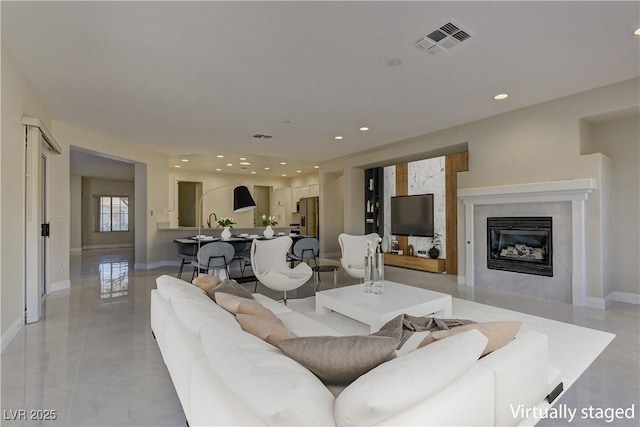 living room featuring a premium fireplace