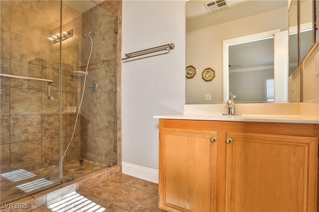 bathroom featuring a shower with door, vanity, and crown molding