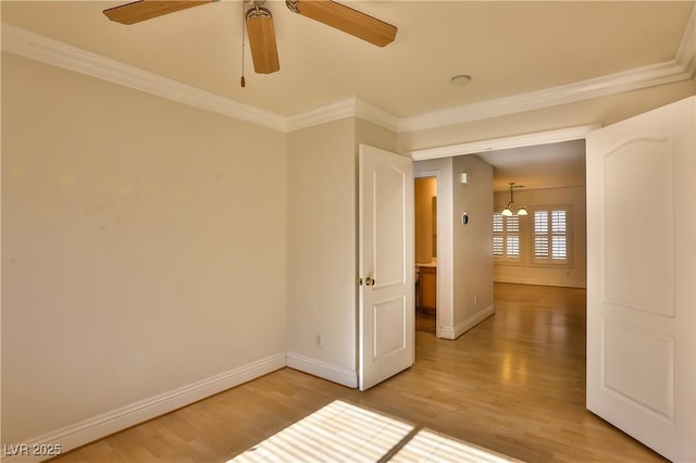 spare room featuring wood-type flooring, ceiling fan, and crown molding