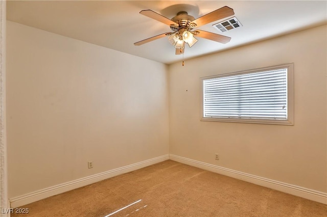 empty room with ceiling fan and light colored carpet