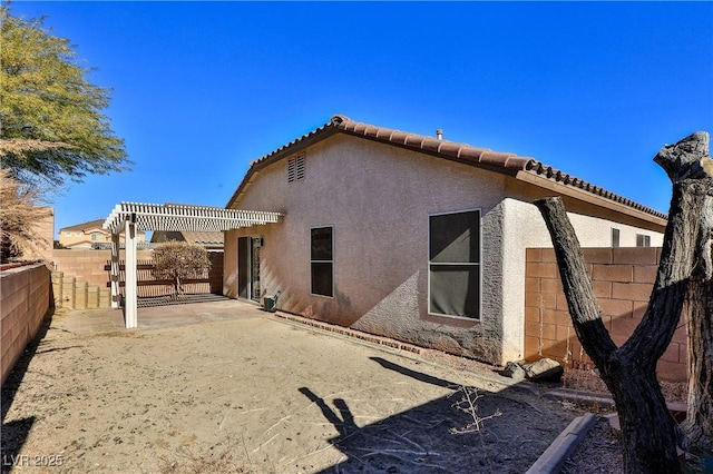 rear view of house with a patio area and a pergola