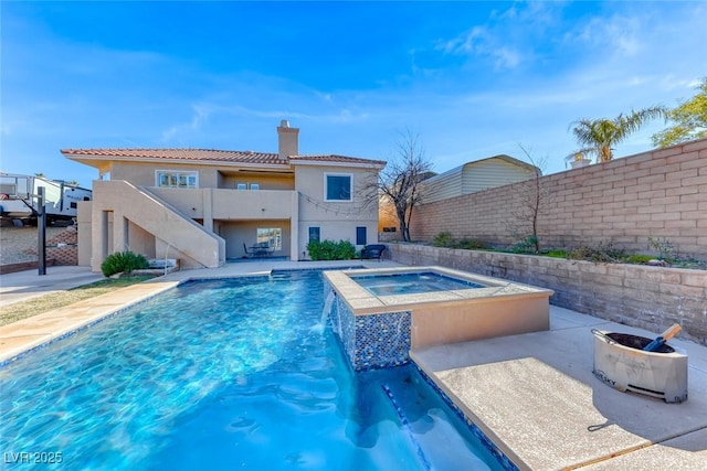 view of pool with pool water feature and an in ground hot tub