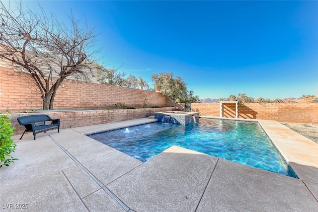 view of pool featuring pool water feature and an in ground hot tub