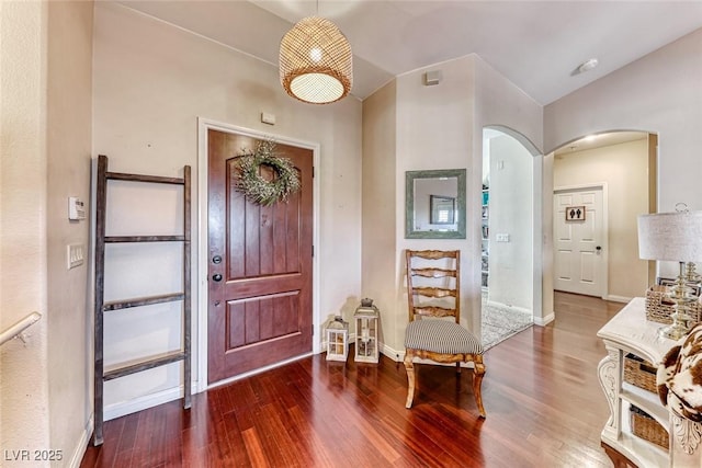 entrance foyer featuring lofted ceiling and hardwood / wood-style floors