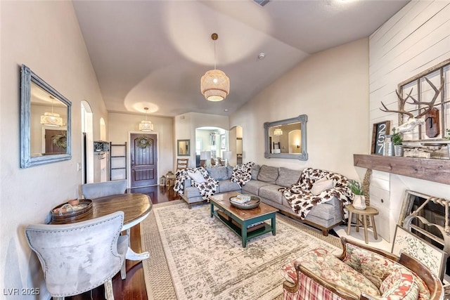 living room with hardwood / wood-style floors and vaulted ceiling