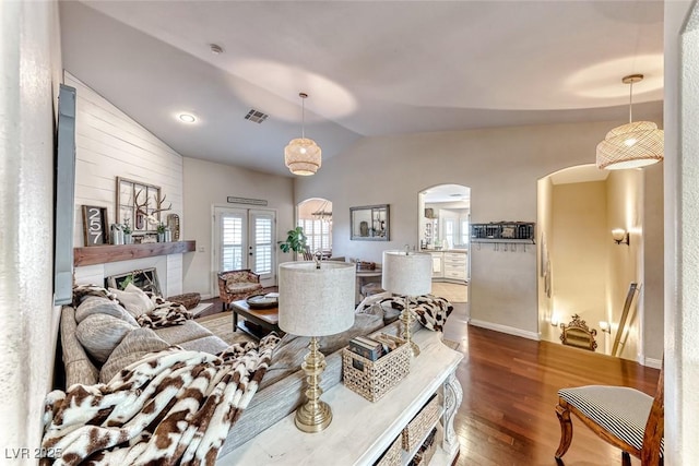 living room with dark wood-type flooring, french doors, and vaulted ceiling