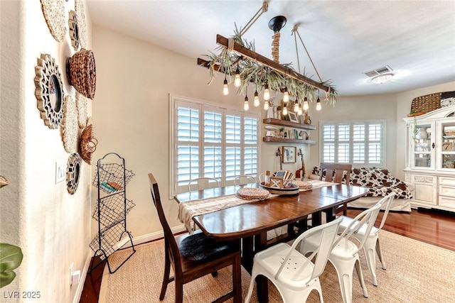 dining space featuring wood-type flooring