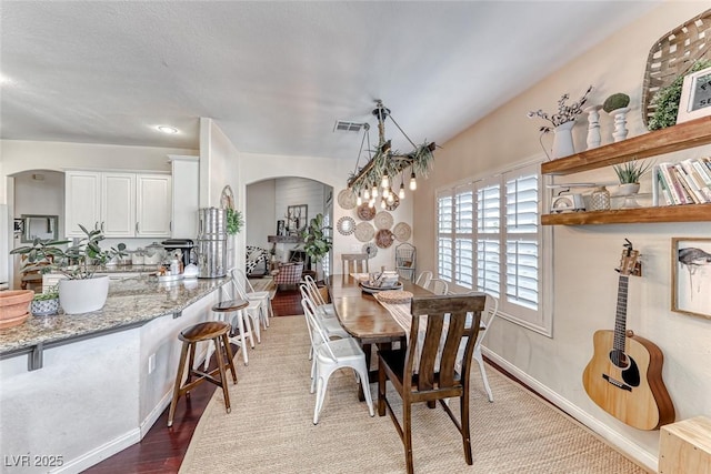 dining space with dark hardwood / wood-style flooring