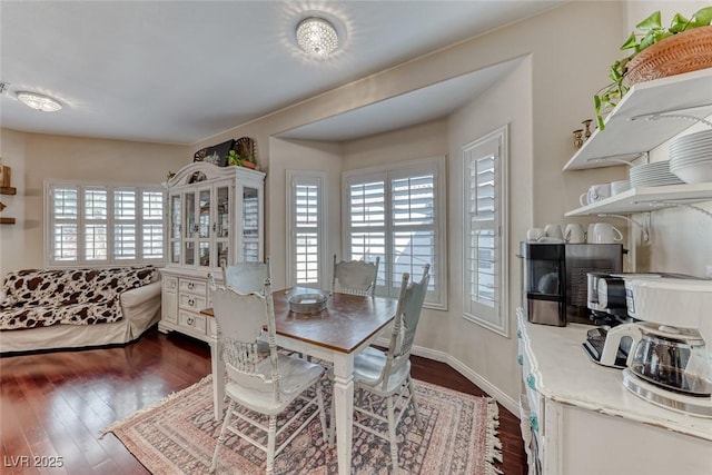 dining area featuring a healthy amount of sunlight and dark hardwood / wood-style floors