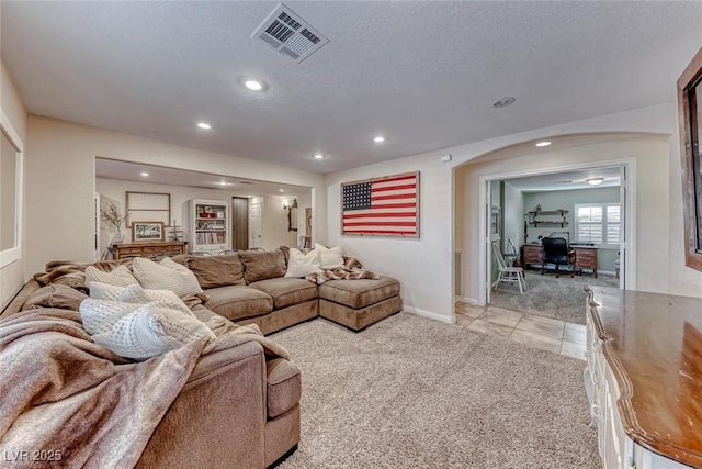 living room featuring light colored carpet and a textured ceiling