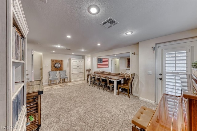 interior space with light colored carpet and a textured ceiling