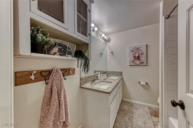 bathroom featuring vanity and a textured ceiling