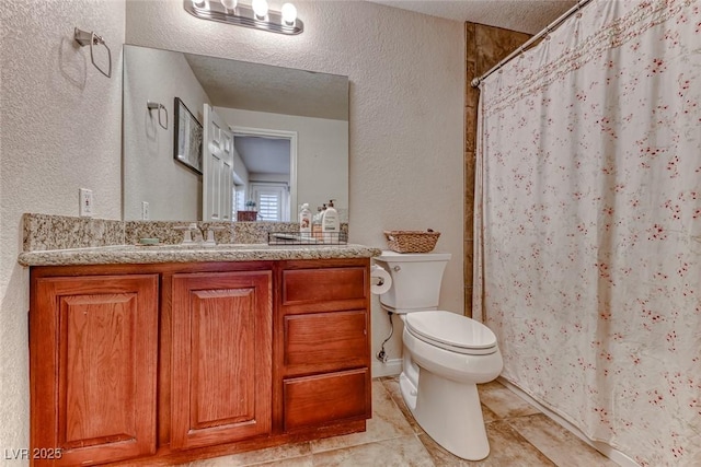 bathroom featuring vanity, toilet, tile patterned floors, a textured ceiling, and a shower with shower curtain