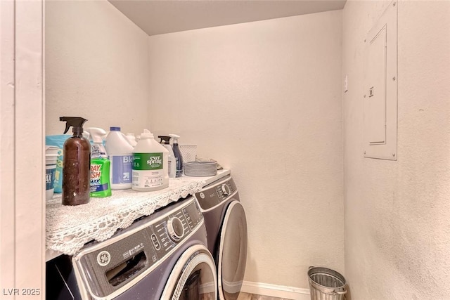 clothes washing area with washing machine and dryer