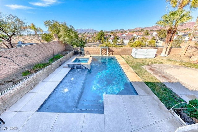 view of swimming pool with an in ground hot tub, a mountain view, and a patio area