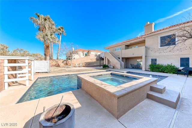 view of swimming pool featuring an in ground hot tub and a patio