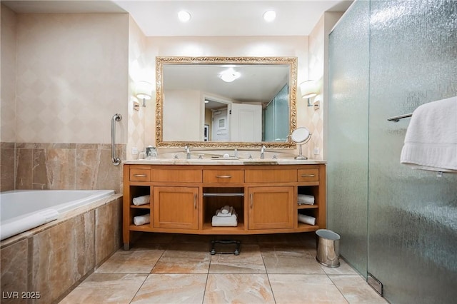 bathroom featuring tile walls, vanity, and plus walk in shower