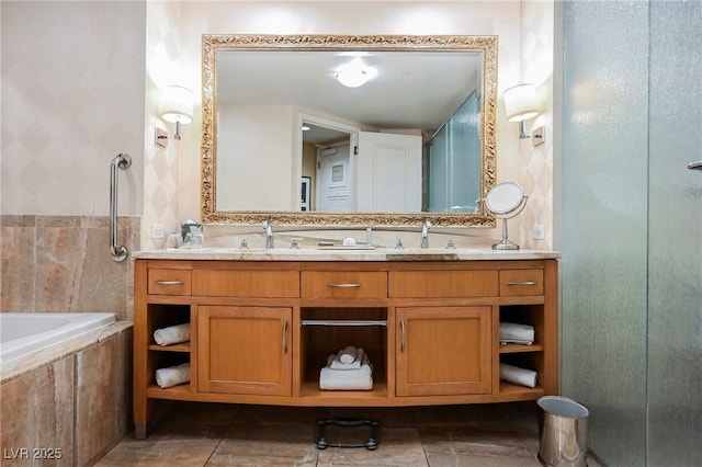 bathroom with tile walls, vanity, and shower with separate bathtub