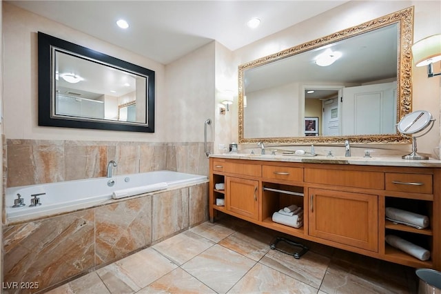 bathroom featuring tiled bath and vanity