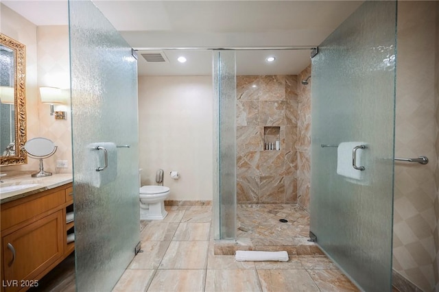 bathroom featuring vanity, toilet, and walk in shower