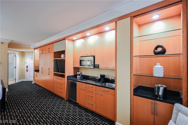 kitchen with sink, dark carpet, and appliances with stainless steel finishes