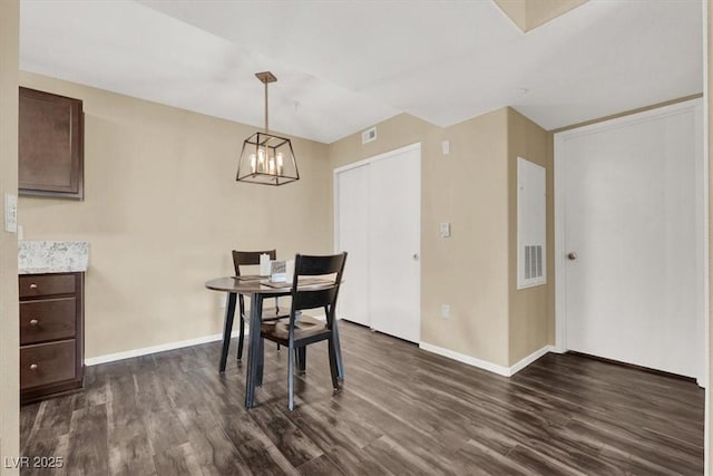 dining room featuring dark wood-type flooring and a notable chandelier