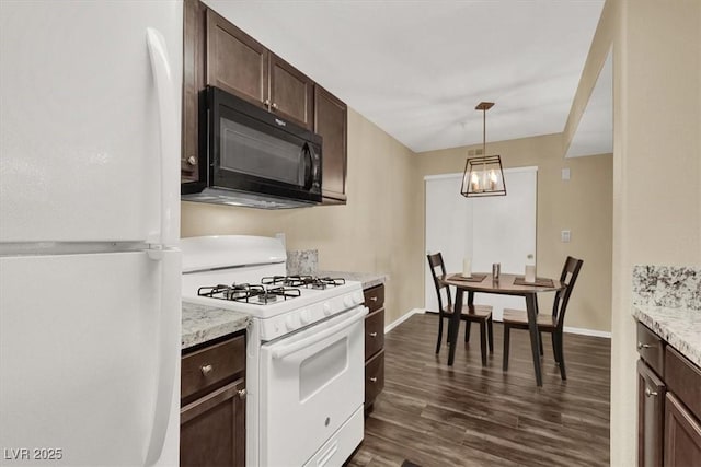 kitchen with white appliances, dark hardwood / wood-style flooring, hanging light fixtures, light stone counters, and dark brown cabinets