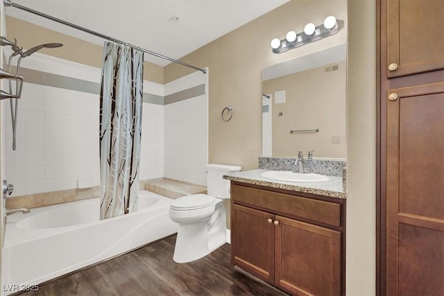 full bathroom featuring hardwood / wood-style flooring, toilet, vanity, and shower / bath combination with curtain