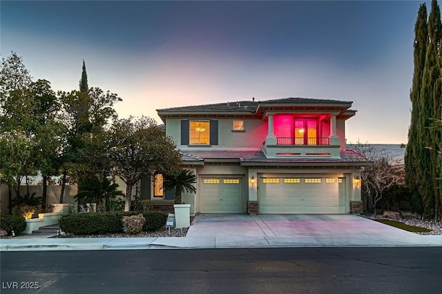 view of front of home featuring a garage and a balcony