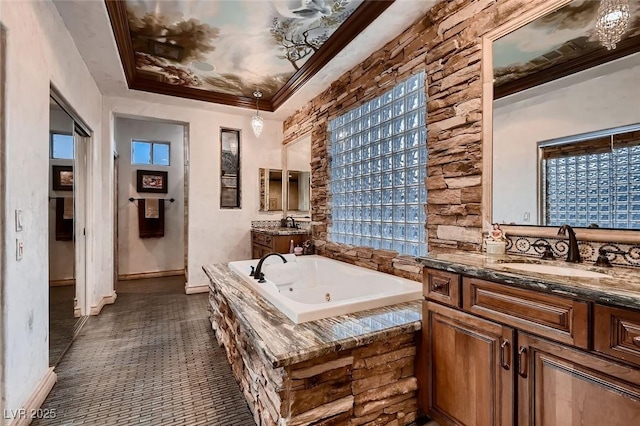 bathroom featuring a relaxing tiled tub, vanity, crown molding, and a healthy amount of sunlight