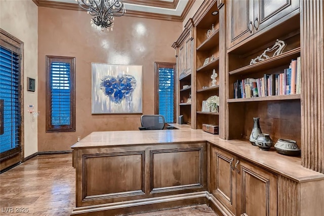 office area featuring hardwood / wood-style floors, crown molding, and a notable chandelier