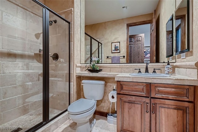 bathroom featuring vanity, toilet, and an enclosed shower