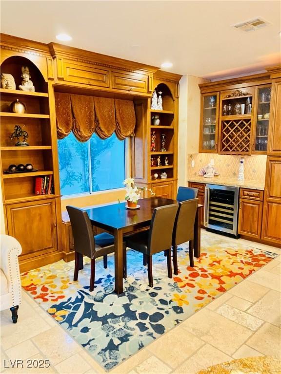 dining space with wine cooler and indoor bar