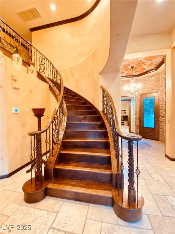 stairs with an inviting chandelier