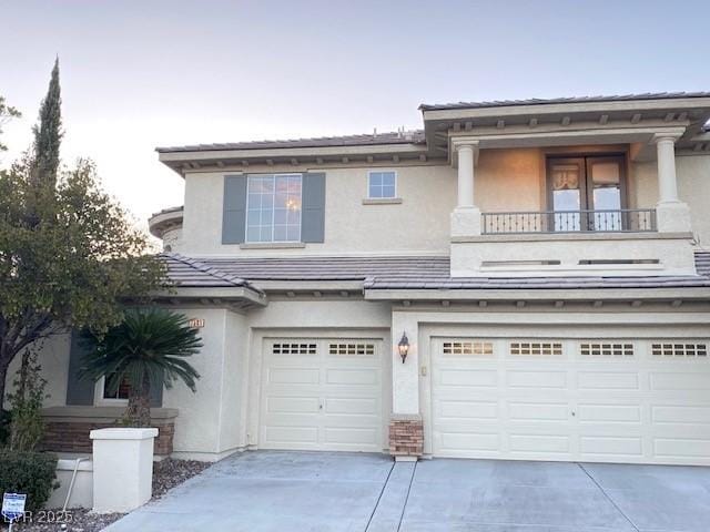 view of front of home with a garage and a balcony