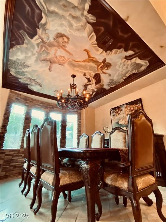 dining room with an inviting chandelier and a tray ceiling