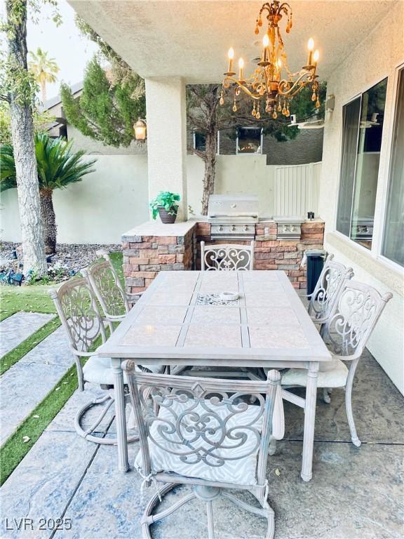 view of patio with area for grilling and an outdoor kitchen