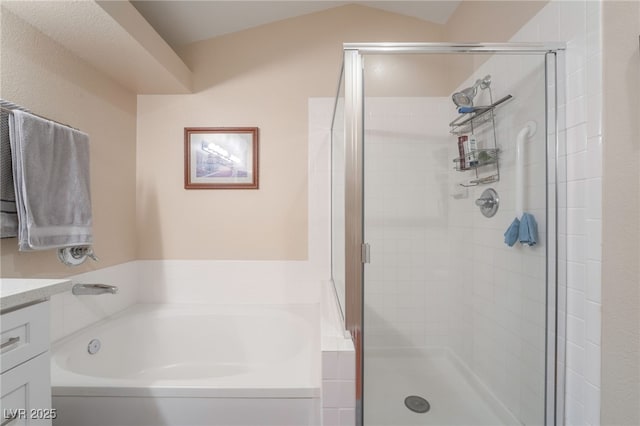 bathroom with shower with separate bathtub, vanity, and vaulted ceiling