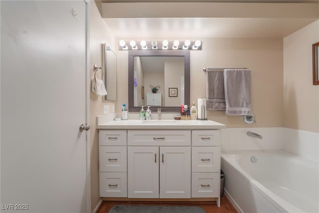 bathroom featuring a tub to relax in and vanity