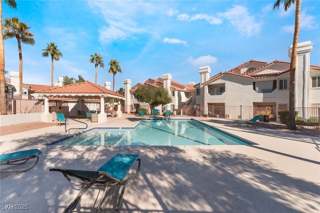 view of swimming pool with a patio and a gazebo