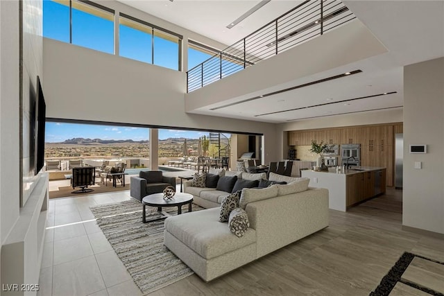 living area featuring a towering ceiling and a mountain view