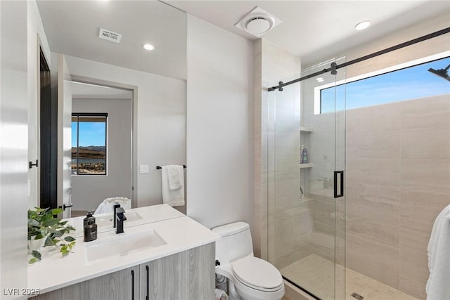 full bathroom with visible vents, toilet, vanity, a shower stall, and recessed lighting