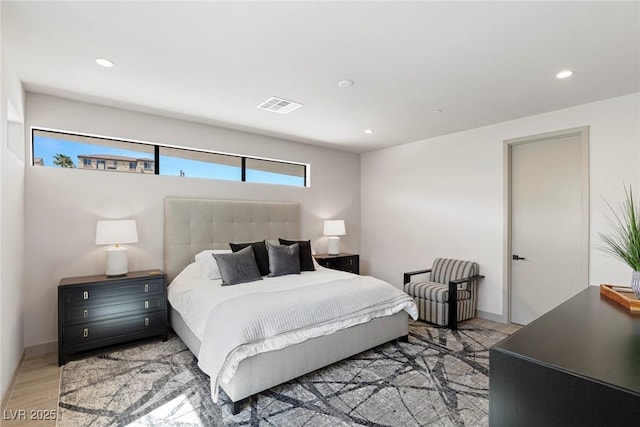 bedroom with baseboards, light wood-style flooring, visible vents, and recessed lighting