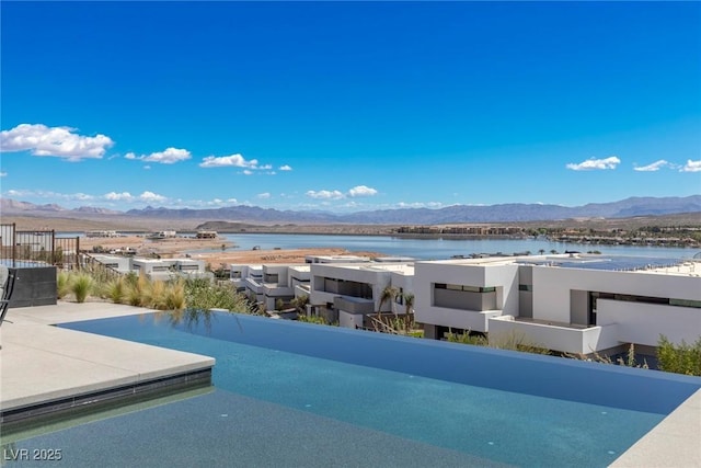 view of pool with a water and mountain view