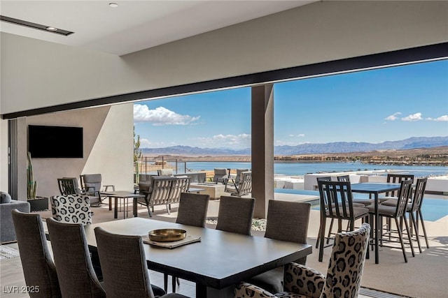 dining space featuring a water and mountain view