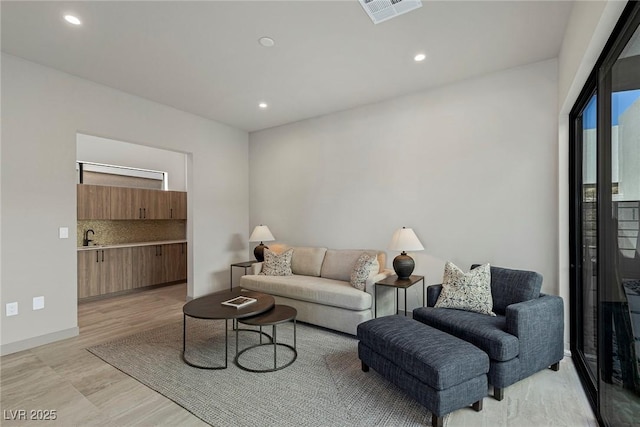 living room with recessed lighting and visible vents