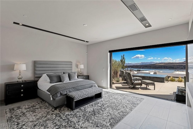 bedroom with access to outside, a water view, and light tile patterned floors