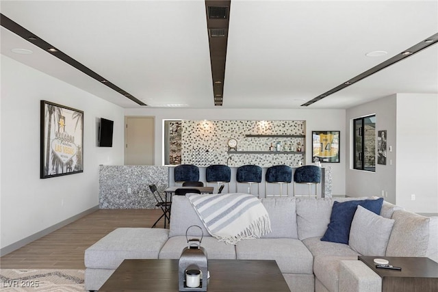 living area with baseboards and light wood-style floors